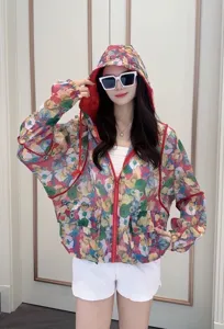 Detailed close-up view of the women's colorful floral print sun protection hooded jacket.