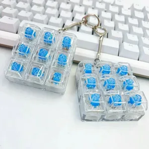 Clear mechanical switch keypad keychain fidget toy with blue switches and metal ring detail.