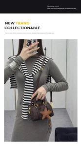 Detail view of the stylish brown plaid Boston crossbody bag with star charm and strap.