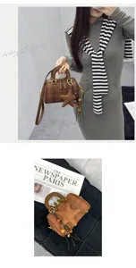 Brown plaid Boston handbag detail view, featuring top handle, chic star pendant and strap.