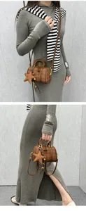 Chic brown plaid Boston bag with star pendant, stylish small handbag for women, versatile cross.