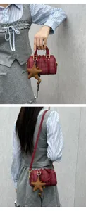 Detail view of red plaid boston bag with star charm, stylish shoulder crossbody small bag.