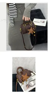 Vintage plaid Boston bag for women, stylish crossbody handbag with star charm and top handle.