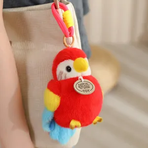 Close-up detail shot of cute red plush parrot bag charm pendant with colorful feathers.