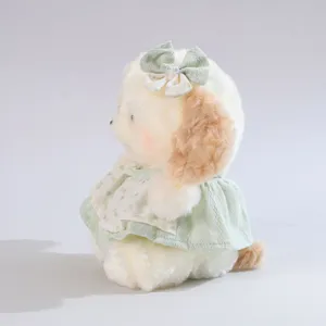 Niedliches Plüschtier Puppe mit grünem Blumenkleid und Schleife, weiches Stofftier.