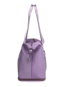 Detailed view of purple travel duffel bag side profile, showing zipper and durable fabric.