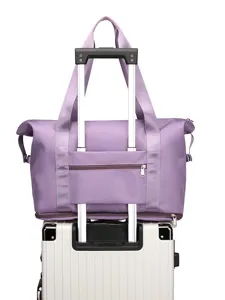 Foldable travel duffel bag with trolley sleeve and luggage strap for outdoor fitness trips.