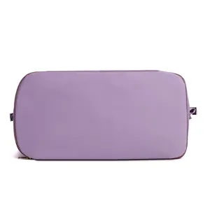 Purple foldable travel duffel bag detail, showing fine fabric texture and secure zipper.