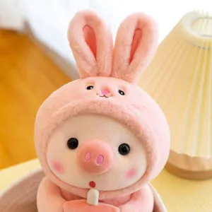 Cute pink bunny pig plush toy close-up detail, soft stuffed doll holding a mini boba cup.