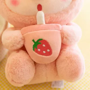 Cute plush pig rabbit doll holding strawberry milk tea cup, soft toy detail view plushie.
