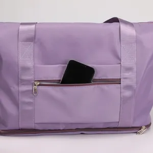 Purple folding travel duffel bag with zipper pocket, durable handles and spacious capacity.