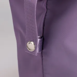 Purple fitness bag detail showing durable nylon fabric, strong strap, and secure snap button.