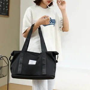 Black folding travel duffel bag detail, large capacity waterproof sports gym bag with handles.