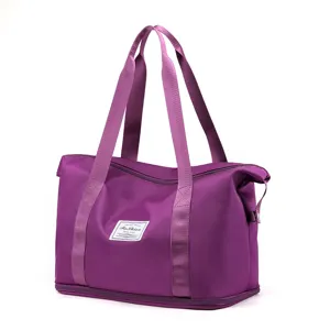 Purple foldable travel duffel bag detail, large capacity fitness gym bag with handles.