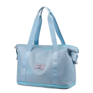 Light blue foldable travel duffel bag, spacious gym tote with bottom compartment and handles.