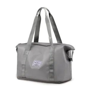 Grey travel duffel bag detail, foldable fitness luggage storage bag with dual handles.