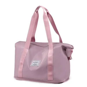 Pink foldable travel duffel bag with durable handles, spacious storage and stylish fabric label.