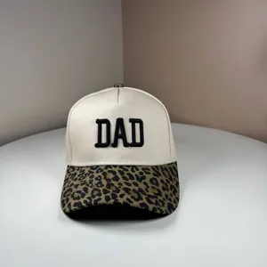 Detail view of washed cotton baseball cap with DAD embroidery and stylish leopard print brim.