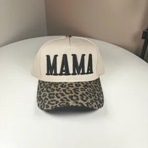 Detail view of the beige cotton baseball cap with leopard print brim and MAMA embroidery.