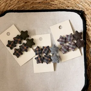 Detail view of Korean retro plaid star hair clips, showing fabric texture and cute design.