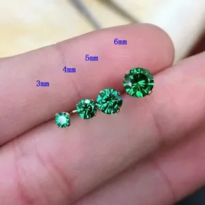 Detailed view of green cubic zirconia four-prong stud earrings in various sizes.