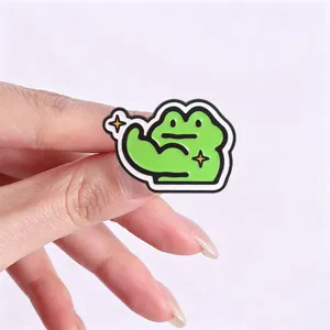 Detailed view of the funny cartoon frog metal enamel pin, cute fitness brooch accessory.