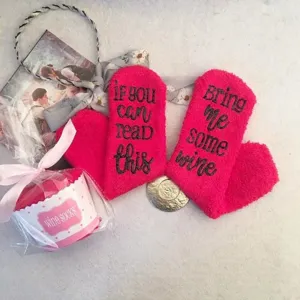 Detailed view of cozy fuzzy winter socks featuring funny letter print on the sole, soft material.