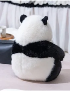 Soft plush black and white panda stuffed animal doll, cute fluffy toy with detailed texture.