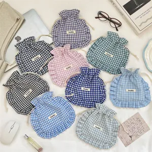 Cute plaid drawstring pouch with ruffled edge, portable fabric storage bag for socks and underwear.