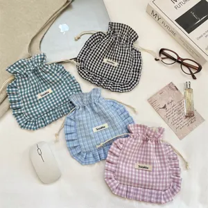 Plaid drawstring pouch with ruffle detail, sweet fabric storage bag for small items, cute and portable.