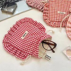 Red and white gingham drawstring bag with ruffled edge, sweet fabric storage pouch.
