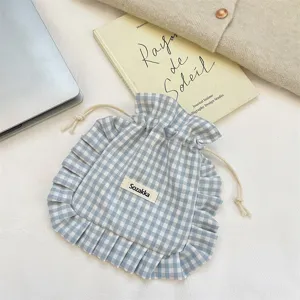 Blue and white plaid drawstring storage bag with cute ruffles, portable fabric organizer.