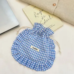 Blue and white gingham ruffled drawstring pouch, cute fabric storage bag for daily organization.