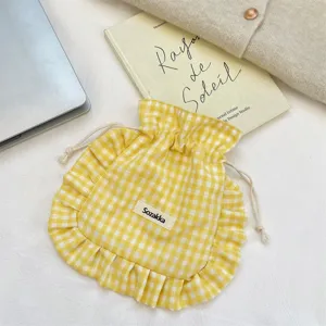 Yellow gingham drawstring pouch with ruffles and cute fabric label for travel storage makeup bag