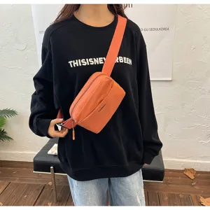 Stylish orange crossbody chest bag with wide strap and zipper closure for casual daily wear.
