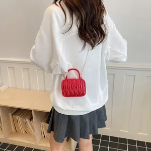 Red acrylic pleated box handbag with chain strap, stylish versatile mini shoulder bag for women.