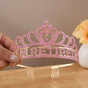 Detail view of a golden rhinestone tiara with I'M RETIRED text for retirement party.