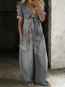 Details of casual grey denim short sleeve wide leg jumpsuit showcasing front tie and pockets.