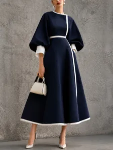Elegant dark blue color-blocked midi dress featuring 3/4 lantern sleeves and chic waist design.