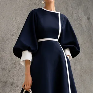 Elegant navy blue contrast midi dress with lantern sleeves and waist cinching design.