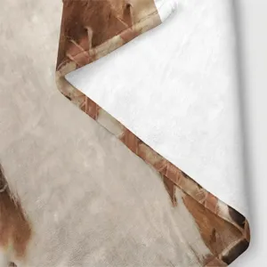 Close-up detail of soft flannel blanket with abstract brown print texture, cozy plush fabric.