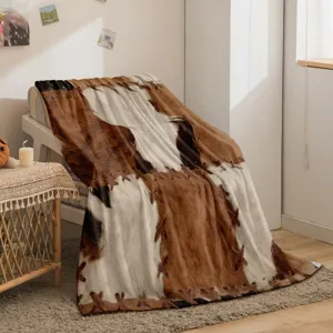 Flannel blanket featuring a realistic cowhide patchwork print design, soft and warm fleece texture.