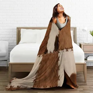 Faux cowhide print flannel blanket, soft throw blanket for bedroom decor and cozy warmth.