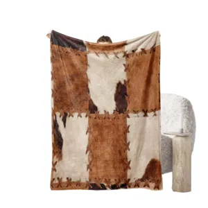 Faux cowhide flannel fleece blanket, rustic patchwork throw blanket for cozy home decor.