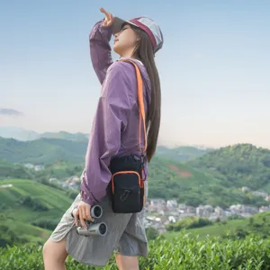 Outdoor tactical crossbody phone bag with vibrant orange strap, perfect for hiking travel.