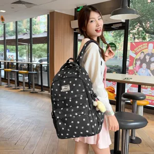 Vue détaillée du sac à dos en toile noire avec imprimé étoiles blanches, style étudiant.