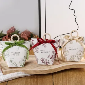 Elegant favor boxes with wooden ring handles and ribbons, perfect for wedding and party gifts.