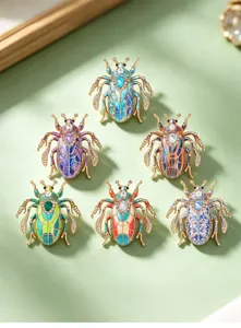 Vintage insect rhinestone brooch detailed shot, elegant beetle metal pin for women clothing.