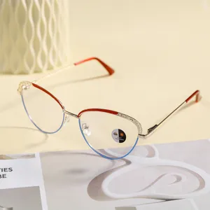 Detail shot of retro cat-eye anti-blue light glasses frame with gold and red metal design.