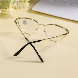 Closeup of stylish gold metal cat eye glasses frame with chic black temple tips for women.